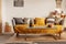 Fashionable living room interior with yellow and grey design and long coffee table in the middle