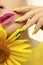 Fashionable manicure on long nails covered with yellow nail polish