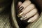 Fashionable manicure with a matte Golden color of nail Polish