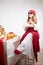 A fashionable modern girl in stylized folk clothes at a table with a samovar, bagels and tea for the Orthodox holiday of