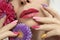 Fashionable multi-colored makeup and manicure on long nails