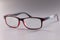 Fashionable plastic glasses red-black on gray background