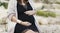 Fashionable pregnant woman in black dress outdoors