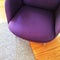 Fashionable purple armchair on wooden floor