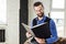 fashionable smiling businessman reading notebook in loft