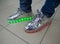 Fashionable sneakers with LED lighting on the legs of a man