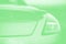 Fashionable sports car. Fragment automobile, details. Green mint color, toned. Copy space