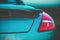 Fashionable sports turquoise car. Fragment, details. Evening light, toned photo
