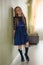 Fashionable style of clothes for children. Little little girl wearing a beautiful lace blue dress. Girl model with long hair