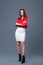 Fashionable style, fashion women`s clothing, color combination. Beautiful brunette girl in white dress and red leather jacket
