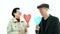 Fashionable stylish Asian elder couple show heart balloon love in the air