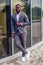 Fashionable and successful African businessman American handsome man in a stylish luxury suit posing on the street