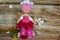 Fashionable Tilda doll made of synthetic winterizer on the background of Christmas decorations and wooden background.