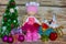 Fashionable Tilda doll made of synthetic winterizer on the background of Christmas decorations and wooden background.