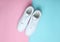 Fashionable white sneakers on a colored pastel background, minimalism, top view, creative layout.