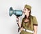 fashionable woman in military uniform and garrison cap, holding bullhorn and screaming