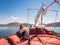 Fashionable woman sitting in a boat. Oman Fjords