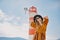 Fashionable woman on vacation against the backdrop of the sea, mountains and a lighthouse. Summer, sunny day, walk along the beach