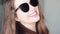 Fashionable woman wearing stylish sunglasses and smiling, beauty face portrait of a caucasian european model as fashion