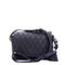 Fashionable women\\\'s black shoulder bag with a textured pattern and a shoulder strap decorated with a tassel