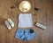 Fashionable women`s look. flat lay feminine clothes and accessories collage: lace top, denim shorts with a passport, clutch bag, s