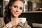 Fashionable young brunette woman having coffee.