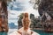 Fashionable young model in boho style dress on boat at the lake