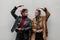 fashionable young two girlfriends girls with in cool leather jacket posing near a gray wall on the street