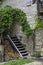 Fassade of an old farm house in trento with wodden stairs