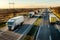 Fast blurred convoy of delivery trucks in high speed motion driving on a highway