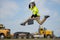 Fast building. Funny construction worker jumping. Excited jump of builders run in helmet. Worker in hardhat