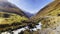 Fast creek in valley amidst mountains