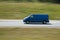 Fast driving blue minivan car