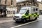 Fast driving Mercedes-Benz Sprinter ambulance car at Canongate street in Edingburgh with strong motion blur effect emphasizing the