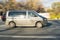 Fast driving Volkswagen Transporter T5 on the city road. Gray minivan rides on street. Commercial auto in fast motion with blurred