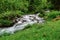 fast flowing torrent with many steps in the mountains while hiking