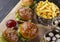 Fast food four sandwiches on a wooden table.