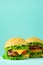 Fast food frame. Delicious meat burgers on blue background. Take away meal. Unhealthy diet concept with copy space