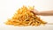 fast food a large pile of golden crispy fries being grab by a hand