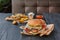 Fast food restaurant dish. Hamburger and fries wedges