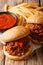 Fast food: sandwich Sloppy Joe with tomato sauce and fries close