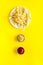 Fast food symbol. French fries on plate on yellow table top-down copy space