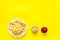 Fast food symbol. French fries on plate on yellow table top-down copy space