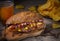 Fast food on the table. Hot dog, chips and beer.