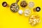 Fast food for TV watching. Snacks on desk. Chips, nuts, rusks and beer on yellow background top view copy space