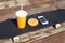 Fast food and unhealthy eating concept - juice cup, hamburger, smartphone on skateboard