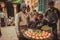 Fast food vendor in crowd of indian people selling meals on narrow street of old city