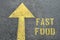 FAST FOOD word on the asphalt road.