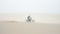 A fast military motorcycle riding through desert dunes