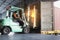 Fast Motion Blur of Forklift Driver Loading Shipment Boxes into Cargo Container Truck. Shipping Warehouse. Freight Truck